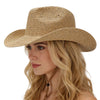 Woman wearing a straw hat against a plain background