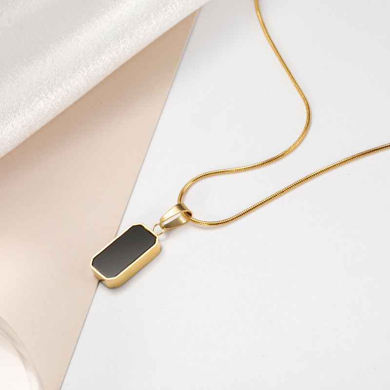 Noir gold necklace pendant detail