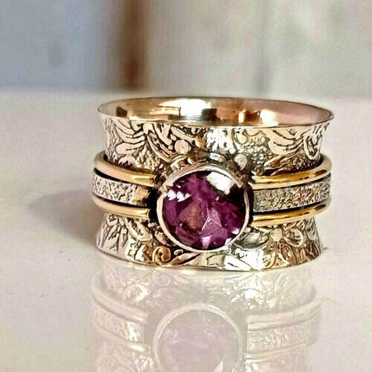 Purple antique ring on finger