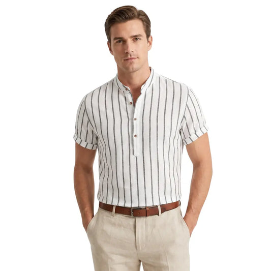 Man wearing a white and navy striped shirt with beige pants on a white background