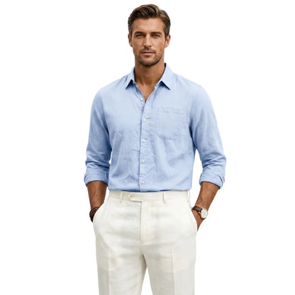Man wearing a light blue shirt and white pants on a white background