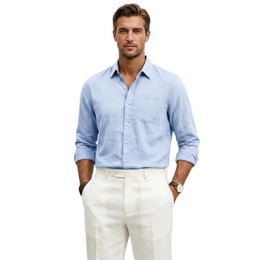 Man wearing a light blue shirt and white pants on a white background