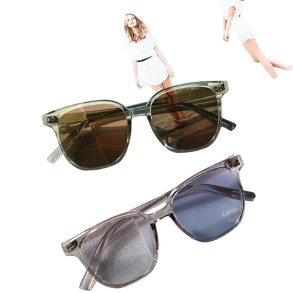 Two pairs of sunglasses on a magazine with a blurred background