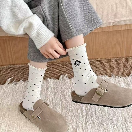 Polka dot puppy socks on feet